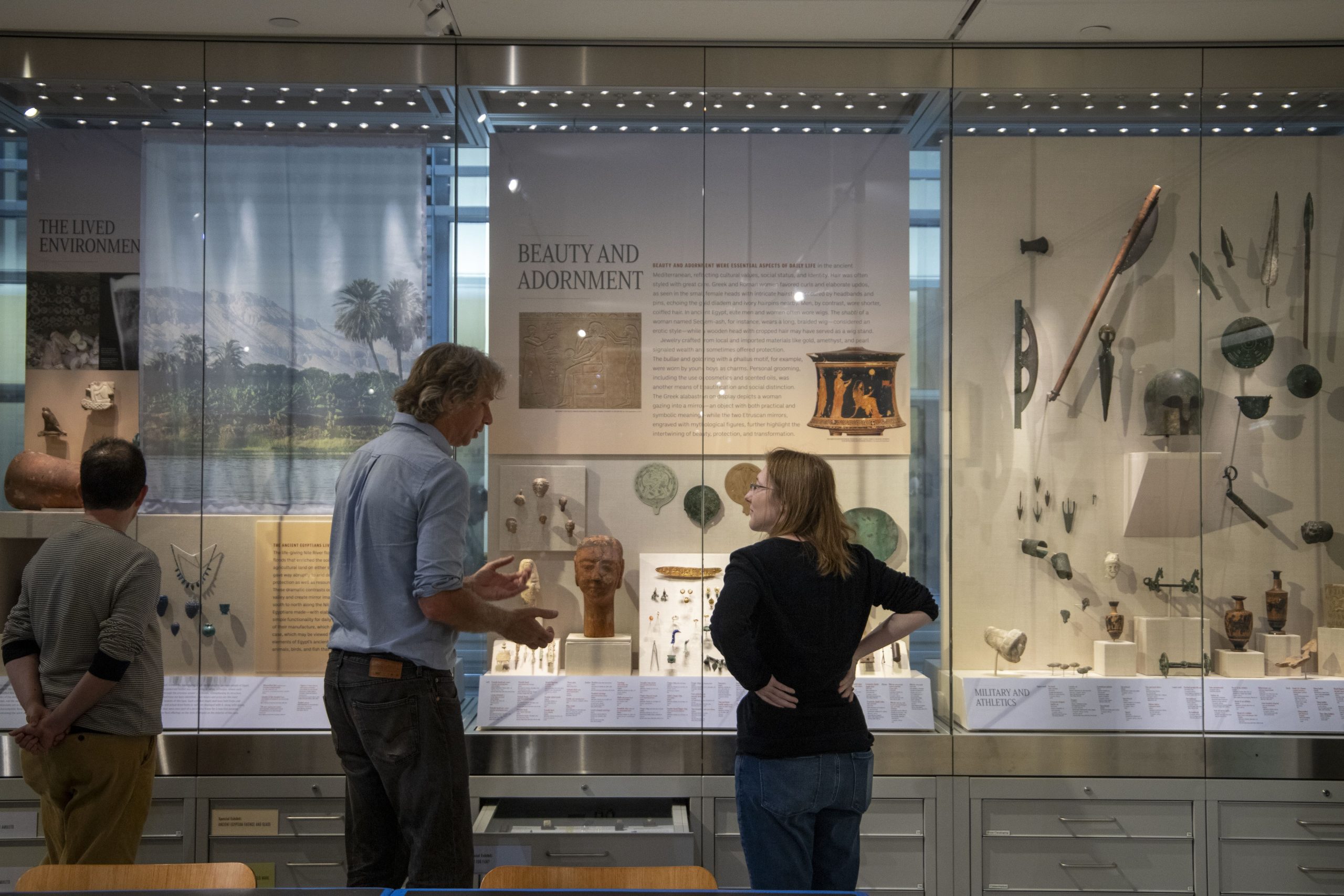 Photo of two people looking at a museum display case.