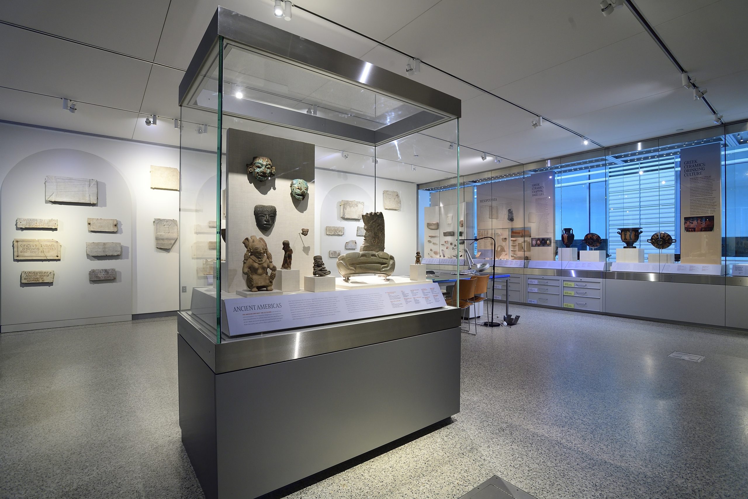 Overview of the interior of a museum showing display cases with ancient artifacts.