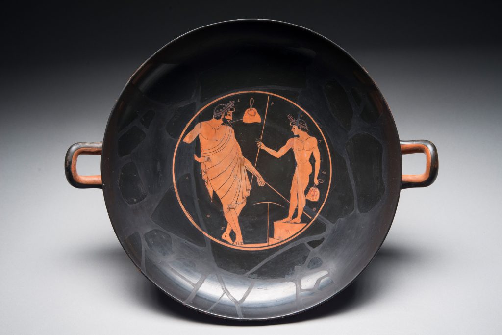 Ancient Greed red-figure kylix drinking cup with an image of a man admiring a naked youth.